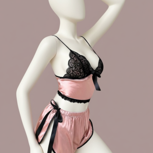 A simple yet stylish two-piece loungewear set for ultimate comfort. Features a cropped cami top with thin straps and matching pull-on shorts, both accented with a subtle bow and delicate contrast trimming.