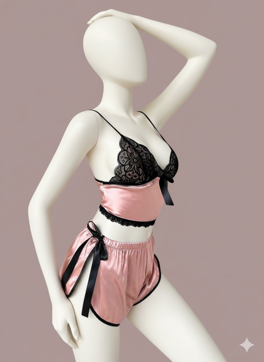 A simple yet stylish two-piece loungewear set for ultimate comfort. Features a cropped cami top with thin straps and matching pull-on shorts, both accented with a subtle bow and delicate contrast trimming.