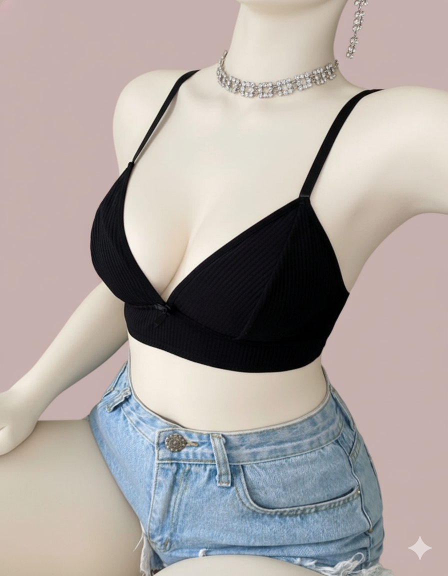 A comfortable and stylish bralette featuring a subtle ribbed texture and a flattering plunge V-neckline. The standout feature is the delicate sheer lace butterfly detail on the back, making it perfect for pairing with open-back tops.