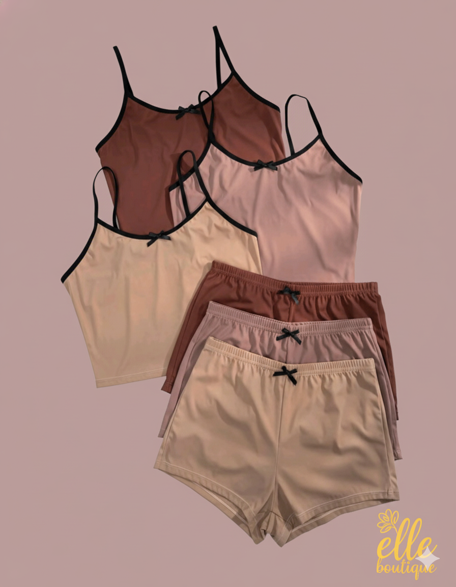 Relax in style with this comfortable two-piece loungewear set. It includes a cropped cami top with delicate spaghetti straps and matching elastic-waist shorts, both adorned with small bow details for a touch of charm.