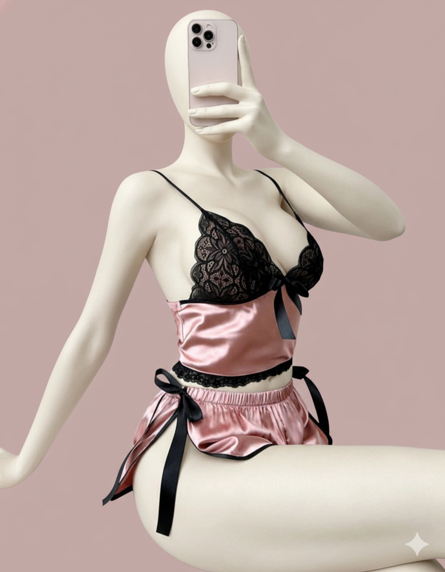 A simple yet stylish two-piece loungewear set for ultimate comfort. Features a cropped cami top with thin straps and matching pull-on shorts, both accented with a subtle bow and delicate contrast trimming.