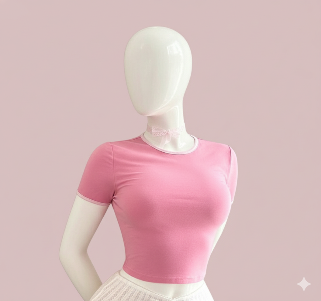 A playful and modern crop top with short sleeves. This fitted t-shirt features a bold heart-shaped cutout on the back and is detailed with contrast trim on the collar and sleeves for a sweet, edgy look.