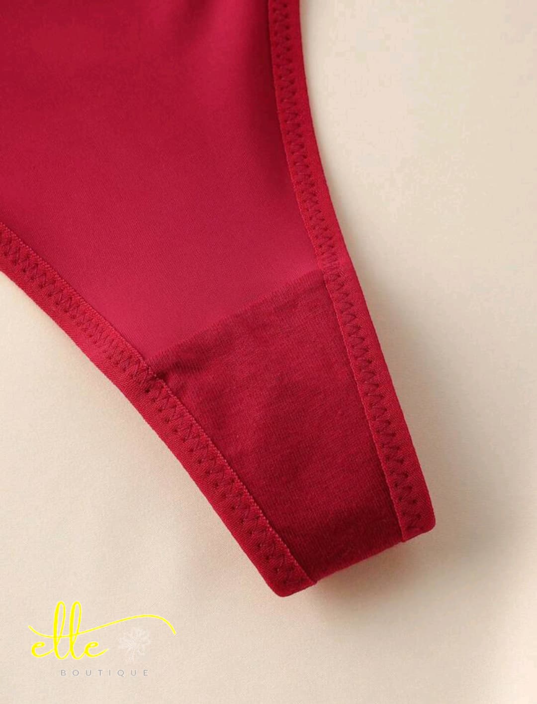 A sleek and stylish thong panty that offers a minimalist yet impactful design. It features smooth fabric and is accented with subtle chain-link style metallic hardware on each hip for a modern, edgy touch.